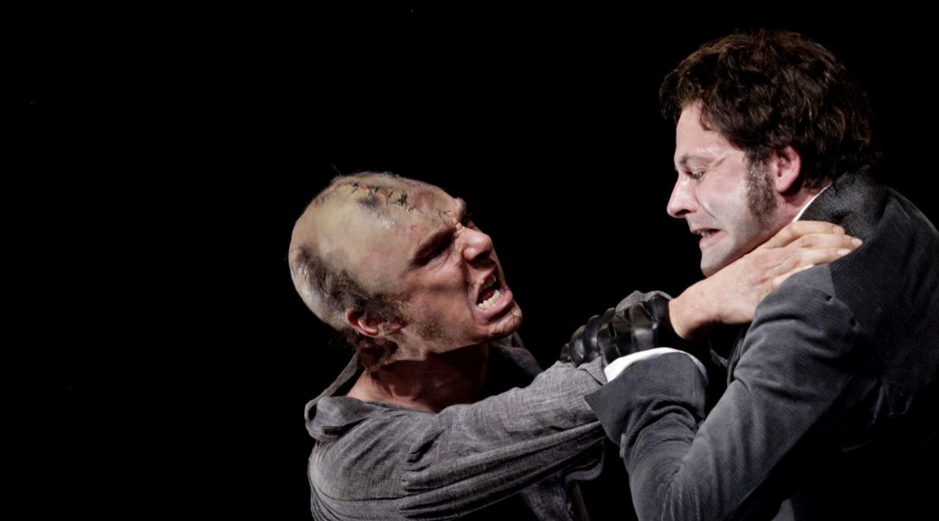 FRANKENSTEIN at the National Theatre. The Creature (Benedict Cumberbatch) and Victor Frankenstein (Johnny Lee Miller) . Photo by Catherine Ashmore